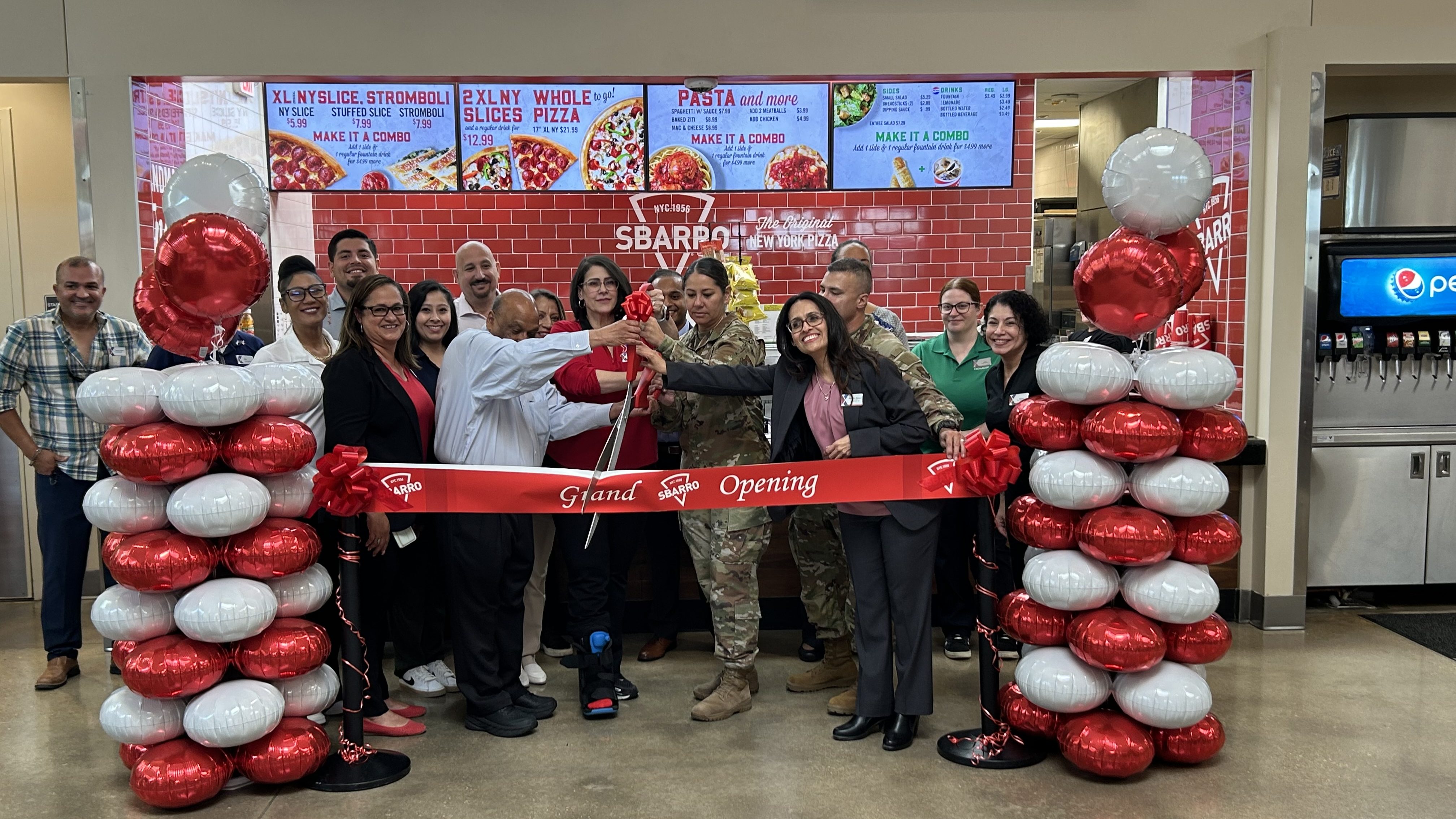 JBSA-Fort Sam Houston team members and Fort Sam Houston command members prepare to cut the ribbon on the new Sbarro.
