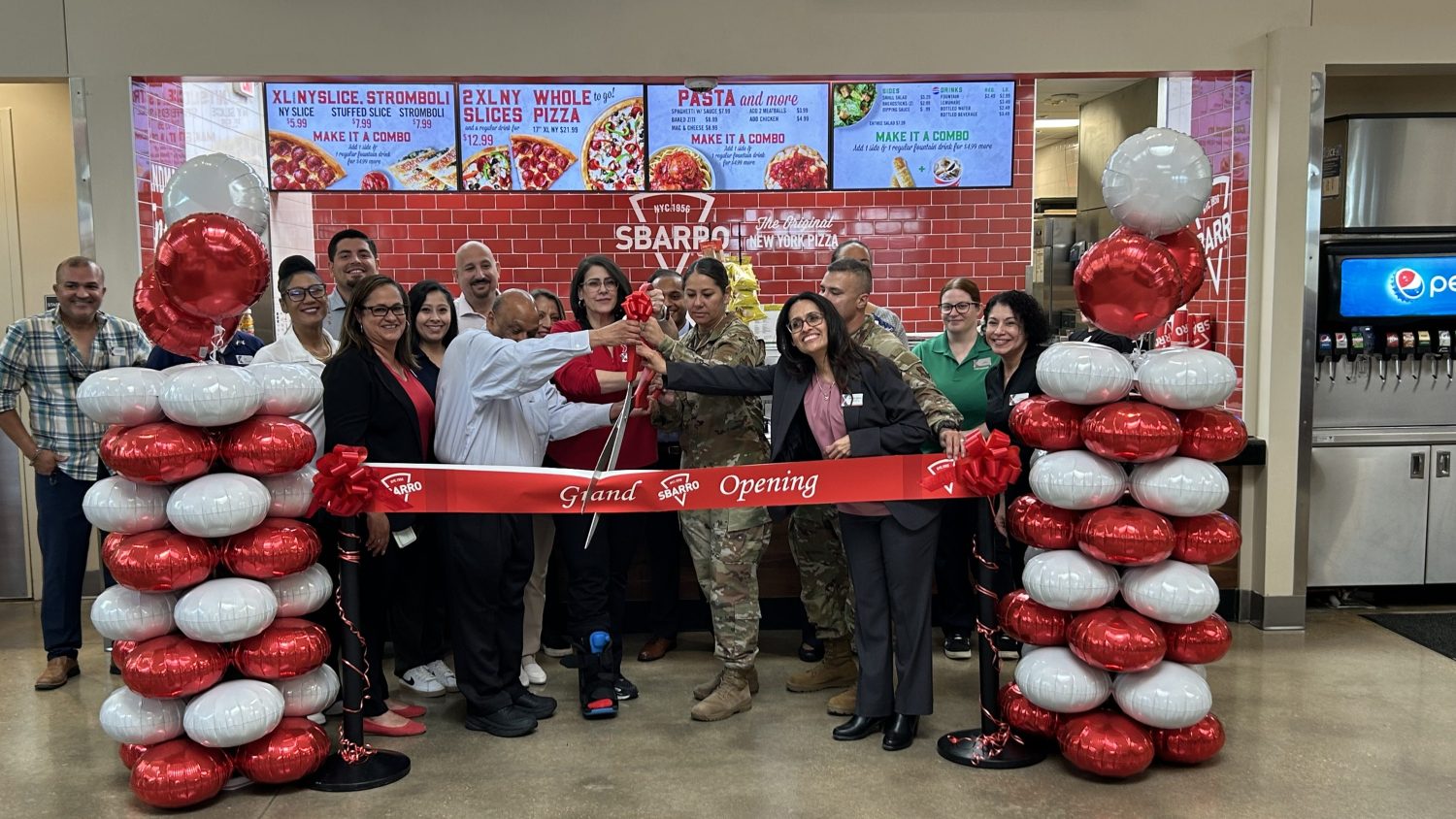 JBSA-Fort Sam Houston team members and Fort Sam Houston command members prepare to cut the ribbon on the new Sbarro.