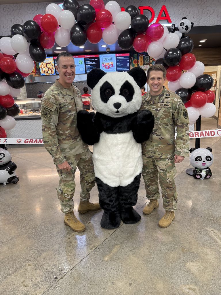 Exchange Pacific Region Commander Air Force Col. Jason L. Bec k and PAC Senior Enlisted Advisor Army Sgt. Maj. Thomas Terry with the Panda Express mascot (unidentified person in a Panda outfit).