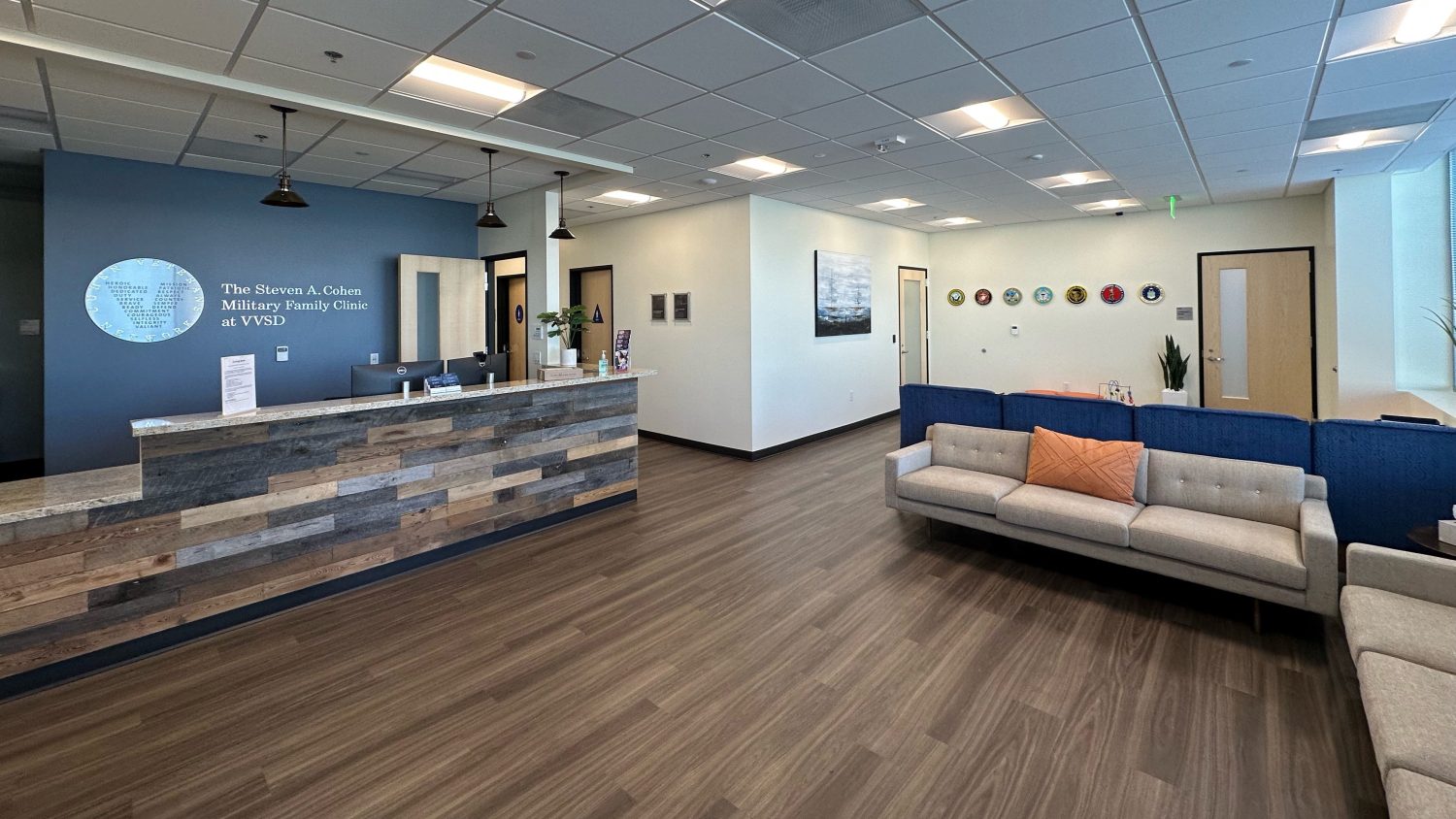 Reception room with couch, front desk.