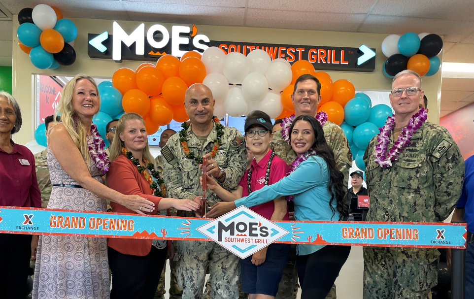 Exchange, Joint Base Pearl Harbor-Hickam Command and Moe's Southwest Grill leaders (five women, three men) cut the ribbon at the new JBPHH Moe's.