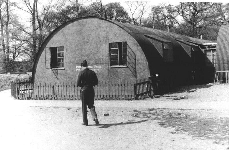 Soldier in front of Exchange in Quonset hut