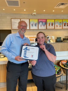 Wendy Skapik receiving service award from Exchange general manager.