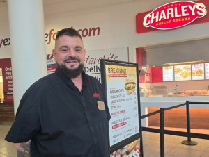 Torsten Hahn head shot with Charleys sign in background