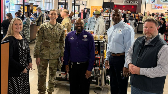 Exchange and Redstone Arsenal officials (two women and three men) inside Redstone Arsenal Goss Express at grand opening.