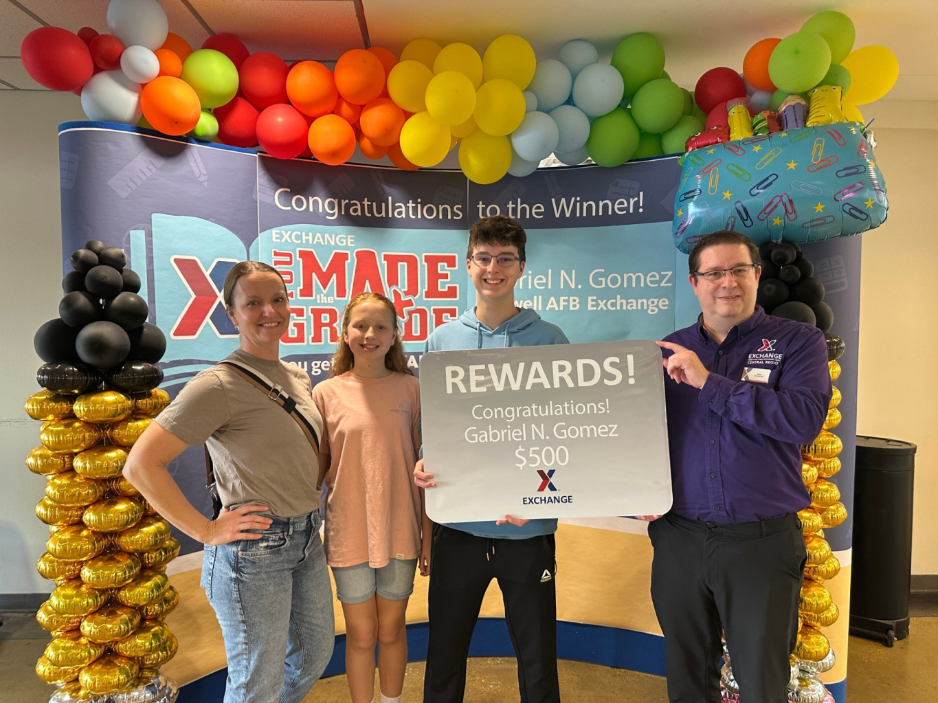 You Made the Grade third-place winner Gabriel Gomez with his mother and sister  mother Jennifer, his and the Maxwell AFB Exchange main store manager.