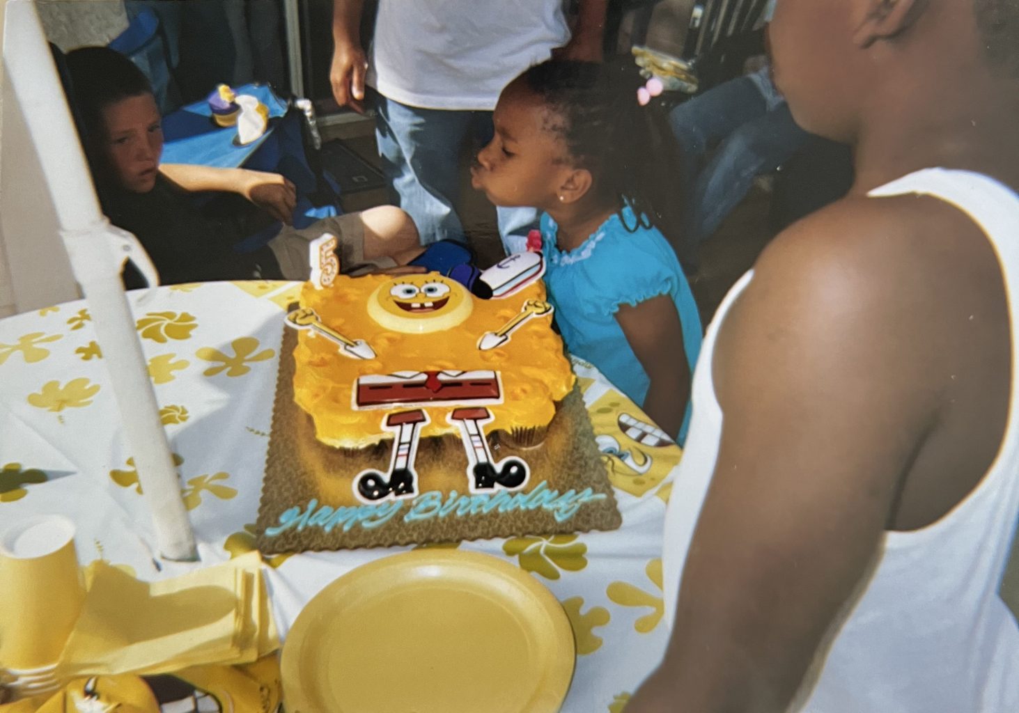 Teonja as little girl with SpongeBob cake.