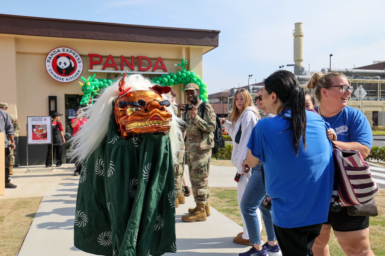 Dragon Dancer entertaining people in line for grand opening of Panda Express on Yokota AB