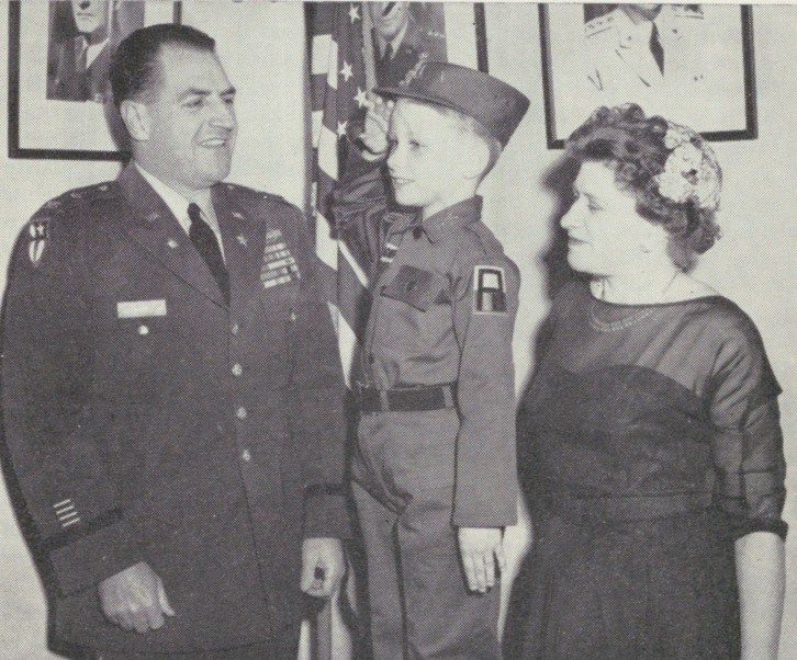 1960 photo of Army officer in uniform, 7-year-old boy in special uniform and boy's mother.