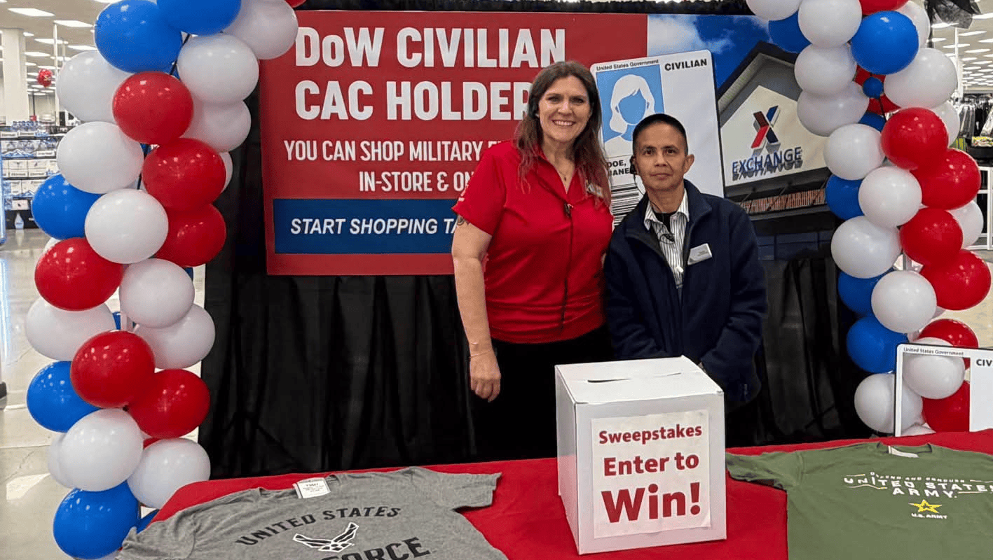 Two associates in front of DoW Civilian CAC Holder sign